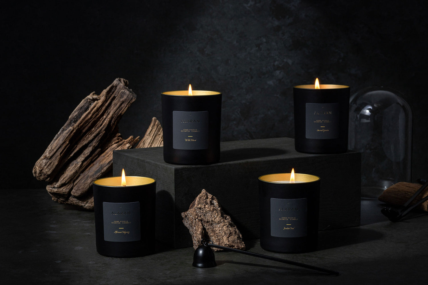 ALARAN Signature Collection lit Candles on a dark grey background