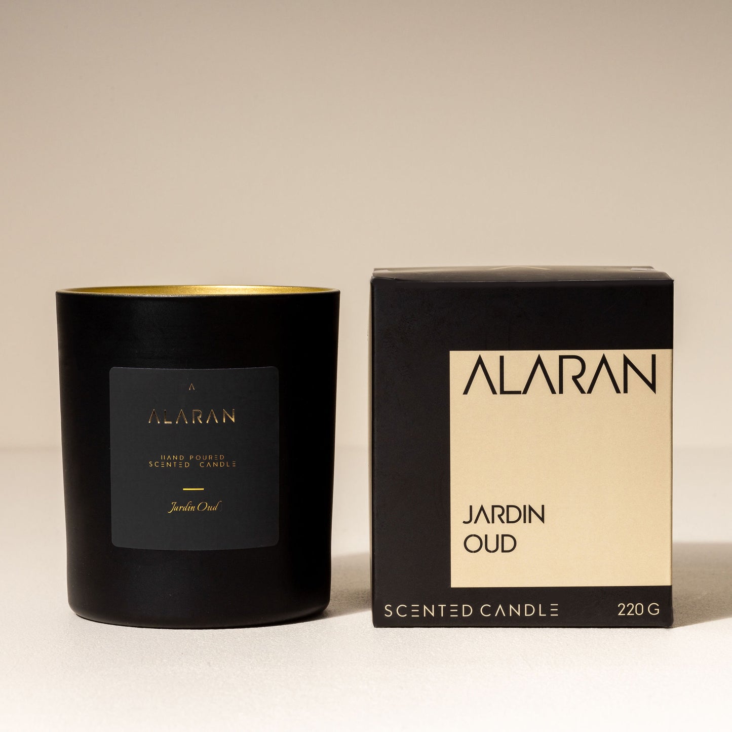 Jardin Oud Candle with packaging on a neutral background